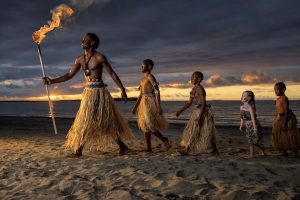 A group of children dressed up as Fijian warriors