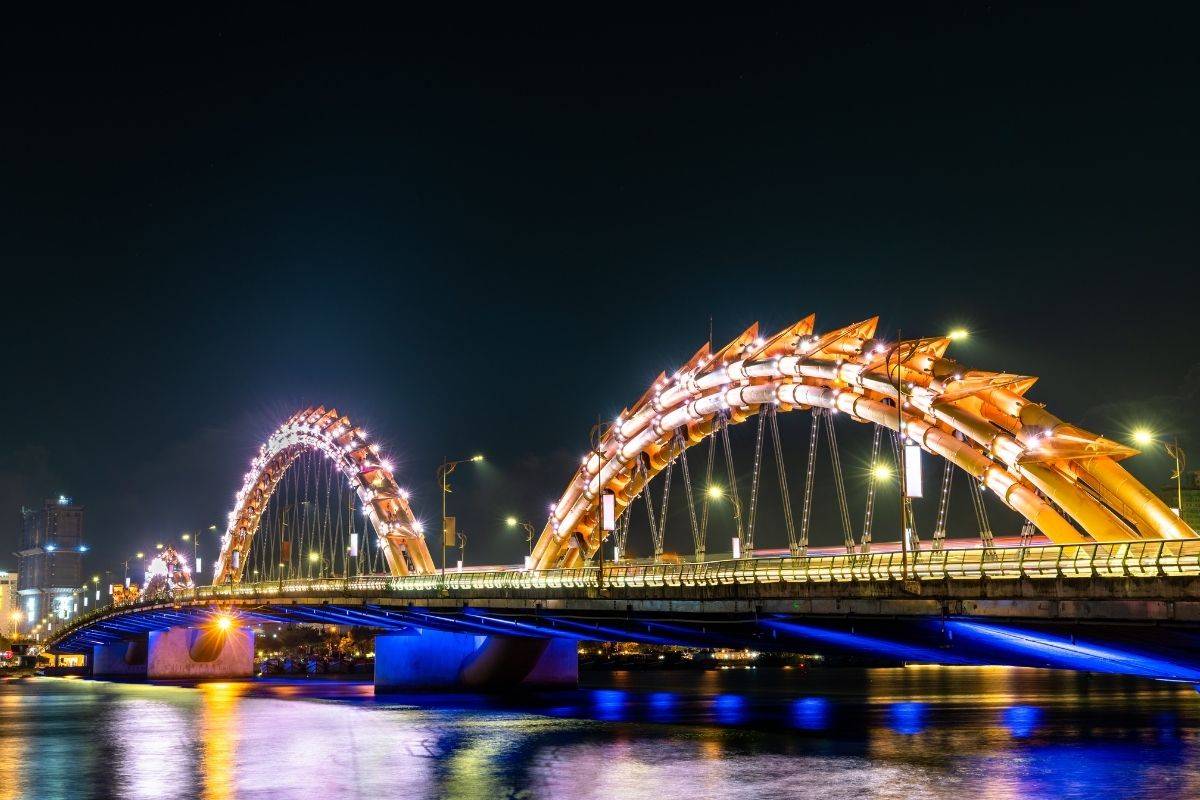 night view of the dragon bridge glowing over the water