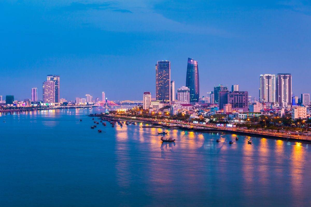 City lights reflecting on the Han River with tall buildings along the waterfront