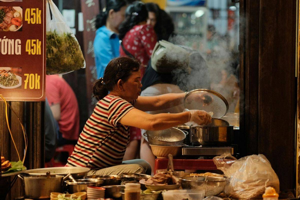 Busy food stall at Son Tra night market with a cook preparing hot dishes