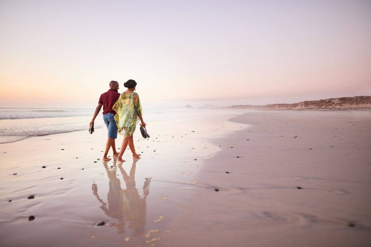 Couple walking along the shoreline at My Khe Beach
