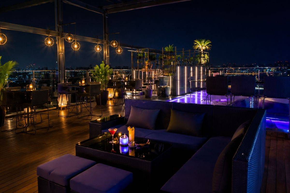 Rooftop lounge with warm yellow lights and purple night lighting at Sky 21 Bar & Bistro