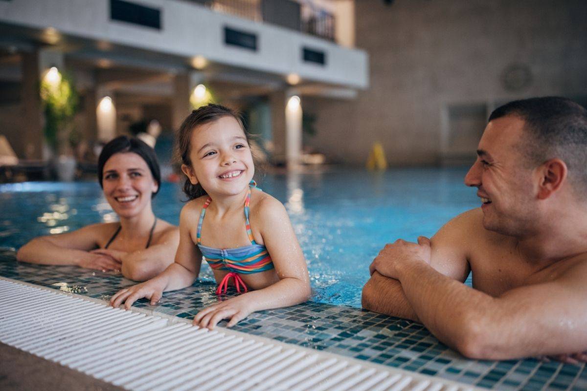 family having fun at the infinity pool at Pullman Danang Beach Resort