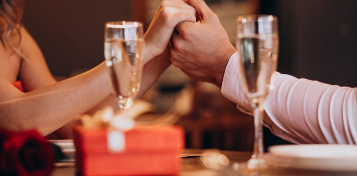 couple-holding-hands-valentines-evening-restaurant