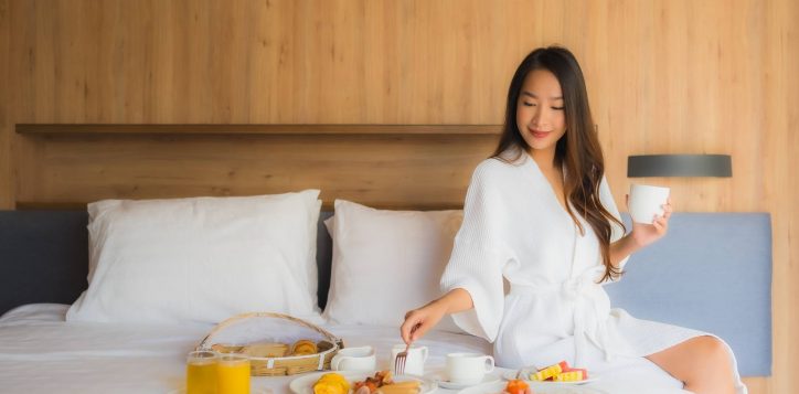 portrait-beautiful-young-asian-woman-happy-enjoy-with-breakfast-bed-bedroom