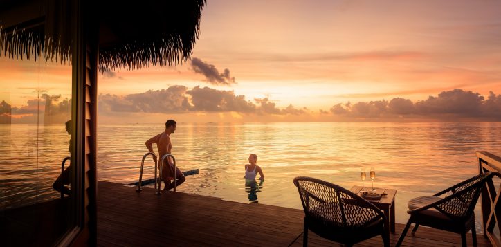 couple-overwater-sunset-pool-villa