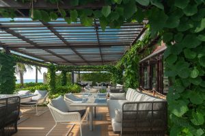 Outdoor seating area at Green Mango Restaurant with vine-covered pergola, Grand Mercure Khao Lak