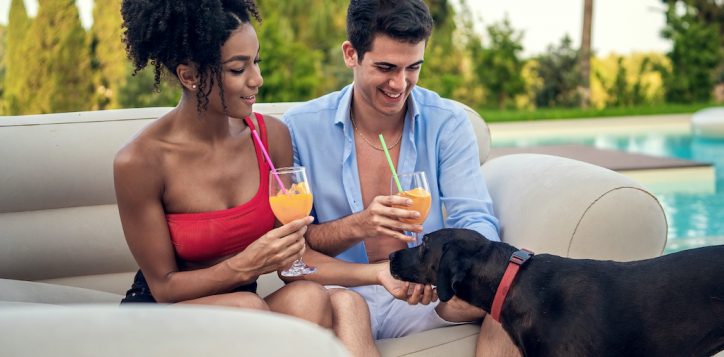interracial-couple-relaxes-with-their-pet-in-a-luxury-villa-or-resort