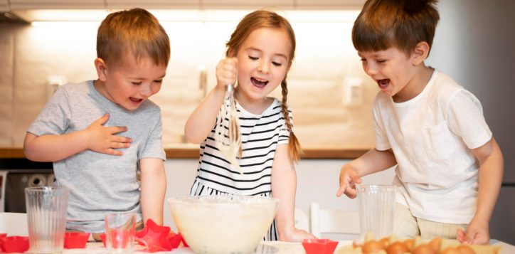 front-view-siblings-cooking-home