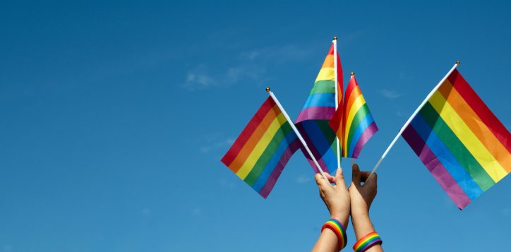 rainbow-flags-showing-in-hands-against-clear-bluesky-copy-space-concept-for-calling-all-people-to-support-and-respcet-the-genger-diversity-human-rights-and-to-celebrate-lgbtq-in-pride-month