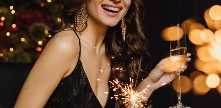 charming-girl-smiles-holds-sparkler-glass-with-champagne-new-year-party