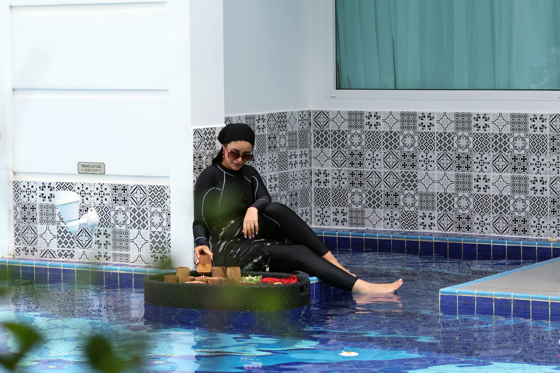 Woman in hijab enjoying Middle East Floating Breakfast by the private pool at Mövenpick Myth Hotel Patong Phuket