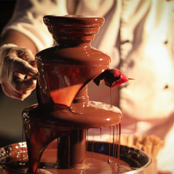 Chef preparing chocolate fountain with fresh strawberries during Chocolate Hour at Mövenpick Myth Hotel Patong Phuket