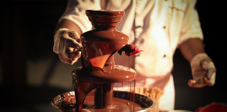 Chef preparing chocolate fountain with fresh strawberries during Chocolate Hour at Mövenpick Myth Hotel Patong Phuket