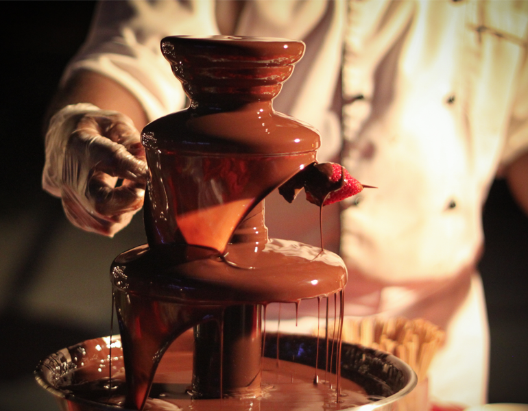 Chef preparing chocolate fountain with fresh strawberries during Chocolate Hour at Mövenpick Myth Hotel Patong Phuket