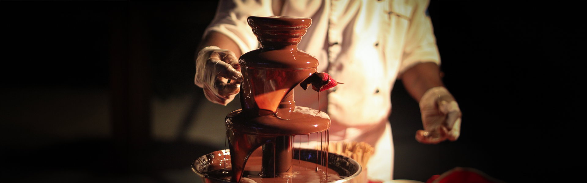 Chef preparing chocolate fountain with fresh strawberries during Chocolate Hour at Mövenpick Myth Hotel Patong Phuket