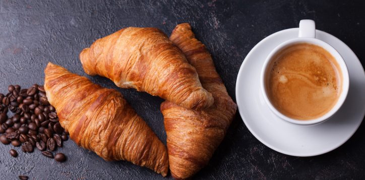 croissants-with-cup-of-coffee-and-coffee-beans-on-dark-wooden-table-2