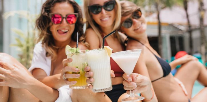 laughing-brunette-woman-pink-sunglasses-celebrating-something-with-friends-during-summer-rest-beautiful-tanned-ladies-drinking-cocktails-enjoying-vacation-1