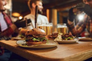 Burger and Pint JLT at La Vue featuring a juicy burger served with a Heineken pint for AED 109 every Thursday from 6 PM to midnight at Pullman Dubai Jumeirah Lakes Towers.