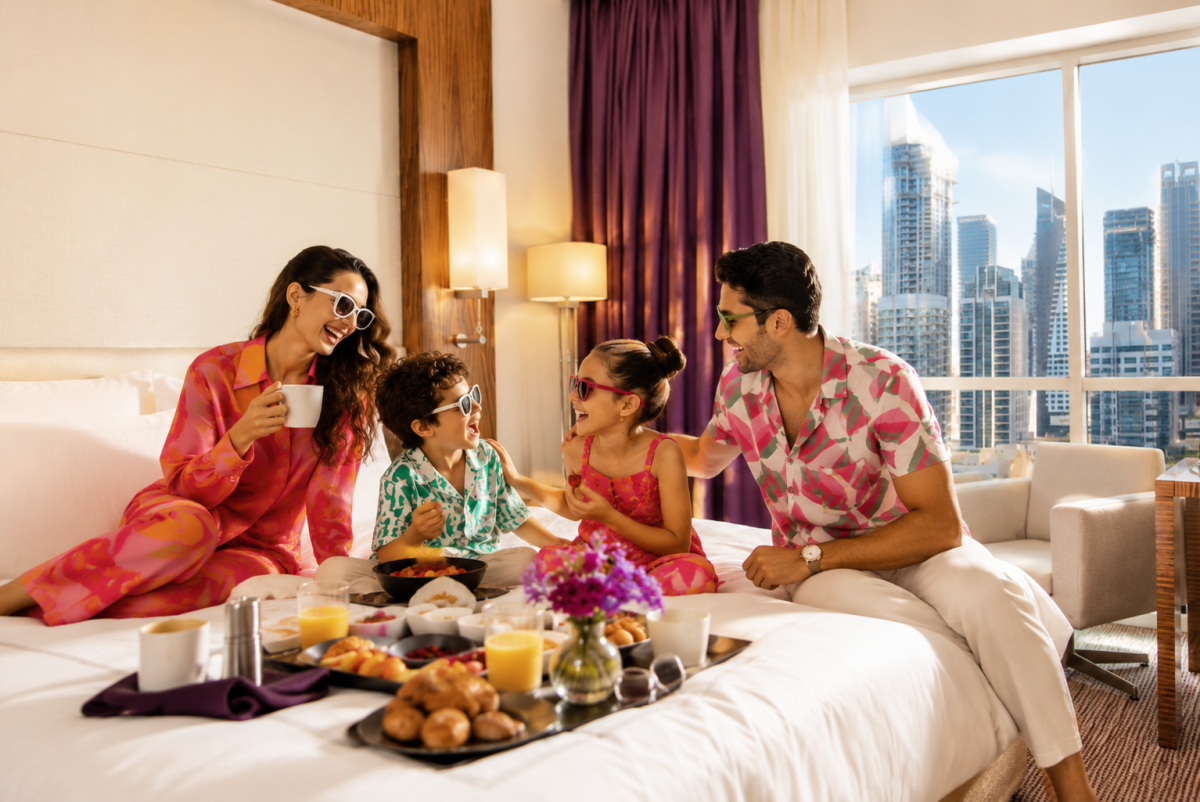 Family enjoying breakfast together during Eid staycation Dubai at Pullman JLT with skyline view