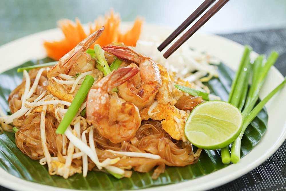 Pad Thai: A stir-fried noodle dish with shrimp or chicken, eggs, tofu, bean sprouts, and a tangy tamarind sauce