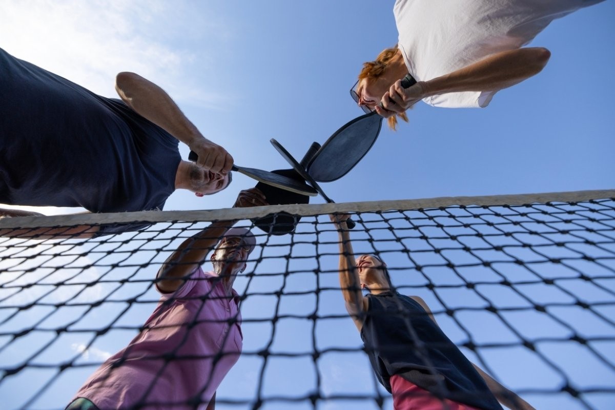 four players enjoy playing pickleball