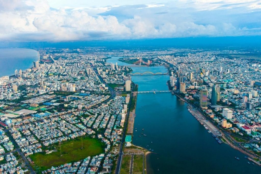 a wide aerial view of a da nang city with rivers, bridges, and dense buildings