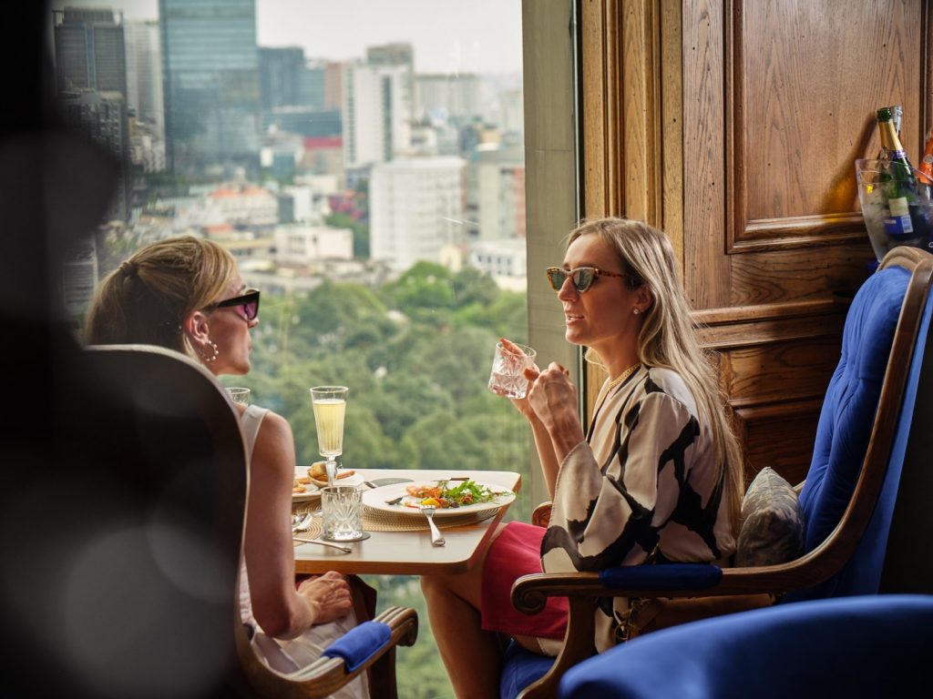 Guests enjoying Sunday brunch with breathtaking city views at Hôtel des Arts Saigon.