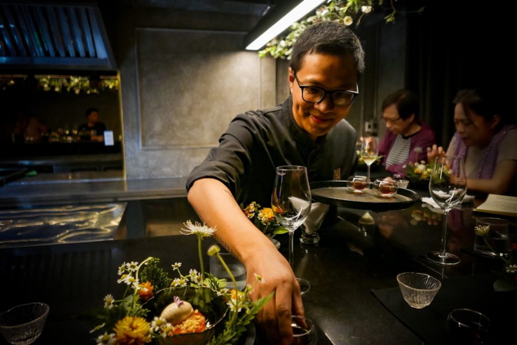 Chef Nghiem Minh Duc presenting dishes at Nous, a modern Vietnamese capsule dining restaurant in Saigon.