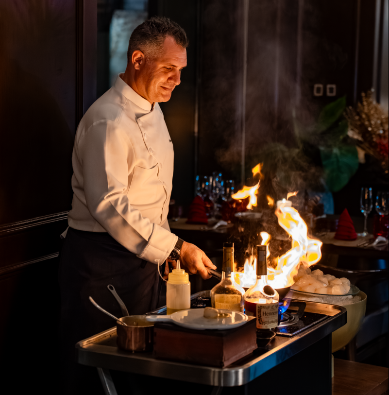 Executive Chef Benoit in action, flambéing foie gras to perfection for the Surf & Turf Buffet.